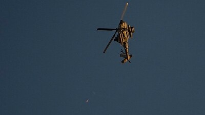 An Israeli Apache helicopter fires flares over the Gaza Strip on Friday, Dec. 1, 2023. (AP) An Israeli Apache helicopter fires flares over the Gaza Strip on Friday, Dec. 1, 2023. (AP)