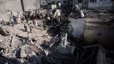 Israel-Hamas War: Palestinians look at destruction after the Israeli bombing In Khan Younis refugee camp in Gaza Strip. (AP) Israel-Hamas War: Palestinians look at destruction after the Israeli bombing In Khan Younis refugee camp in Gaza Strip. (AP)