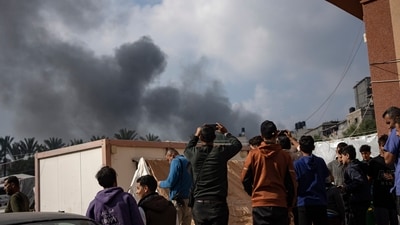 Israel-Hamas War: Palestinians look at smoke following an Israeli airstrike in Khan Younis, Gaza Strip. (AP)
