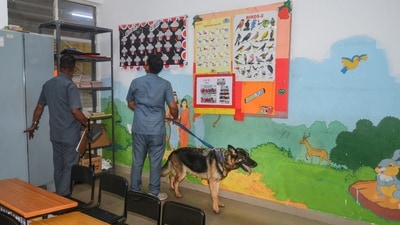 Bengaluru: Members of a police dog squad search the premises of a school after 48 private schools received an email with a bomb threat on its premises. (PTI) Bengaluru: Members of a police dog squad search the premises of a school after 48 private schools received an email with a bomb threat on its premises. (PTI)