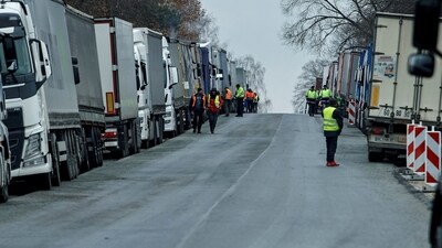 Polish truckers burn wood to keep warm as they block crossings at Ukrainian border near the village of Hrebenne, Poland (REUTERS)