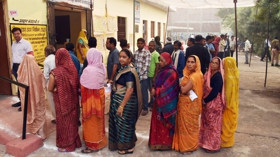 Voters queue up to cast their votes for the Madhya Pradesh Assembly elections.