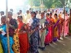 Voters stand in queue to cast their votes for the Telangana Assembly elections