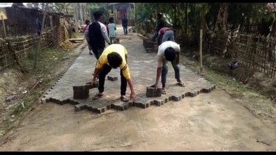 Interlocking tiles being laid in a bylane by workers (For representation only) Interlocking tiles being laid in a bylane by workers (For representation only)