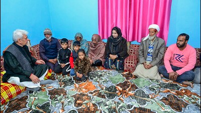 J&K L-G Manoj Sinha meets the kin of havildar Abdul Majid, who was killed in an encounter with terrorists in Rajouri, at Ajote in Poonch district on Saturday. (PTI)