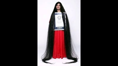 Smita proudly displaying her long tresses while holding the Guinness World Records certificate. (Sourced) Smita proudly displaying her long tresses while holding the Guinness World Records certificate. (Sourced)