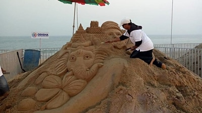 A picture from the 2019 edition of the International Sand Art Festival, at Chandrabhaga beach in Konark, Puri, shows a sand artist giving a finishing touch to their sculpture. (File Photo) A picture from the 2019 edition of the International Sand Art Festival, at Chandrabhaga beach in Konark, Puri, shows a sand artist giving a finishing touch to their sculpture. (File Photo)