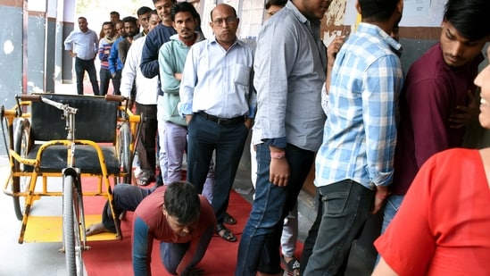 Jaipur, Nov 25 (ANI): A specially-abled voter makes his way through the queue as he arrives to cast his vote for the Rajasthan Assembly Elections, in Jaipur on Saturday. (ANI Photo) Jaipur, Nov 25 (ANI): A specially-abled voter makes his way through the queue as he arrives to cast his vote for the Rajasthan Assembly Elections, in Jaipur on Saturday. (ANI Photo)