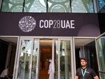 People walk past a COP28 sign at the venue of the United Nations climate summit in Dubai(AFP)