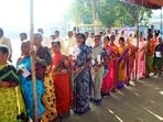 Voters stand in queue to cast their votes for the Telangana Assembly elections