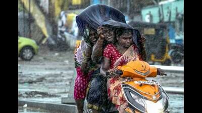 Commuters during heavy rain owing to Cyclone Michaung, in Chennai, Sunday. (PTI) Commuters during heavy rain owing to Cyclone Michaung, in Chennai, Sunday. (PTI)