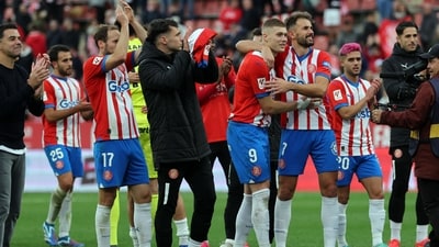 Girona's Spanish coach Michel (L) and players celebrate at the end of the La Liga match against Valencia CF at the Montilivi stadium. (AFP) Girona's Spanish coach Michel (L) and players celebrate at the end of the La Liga match against Valencia CF at the Montilivi stadium. (AFP)