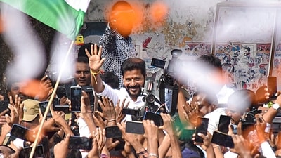 Congress Telangana President A Revanth Reddy greets party workers and supporters celebrating the party's lead during counting of votes for Telangana Assembly elections (PTI) Congress Telangana President A Revanth Reddy greets party workers and supporters celebrating the party's lead during counting of votes for Telangana Assembly elections (PTI)