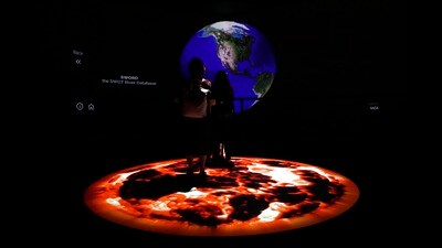 People look at artwork by Yiyun Kang at the COP28 U.N. Climate Summit, Sunday, in Dubai, United Arab Emirates. (AP)