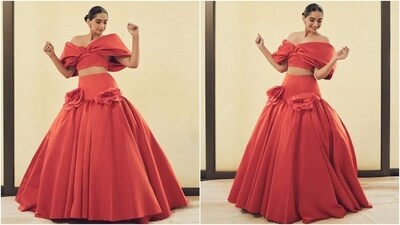 Earlier, Sonam Kapoor attended a fashion event with her husband, Anand Ahuja. She wore an orange Giambattista Valli ensemble for the occasion. It features an off-the-shoulder blouse and a voluminous skirt adorned with floral applique work on either side. She wore the ensemble with striking jewels, including rings and floral-shaped earrings. (Instagram) Earlier, Sonam Kapoor attended a fashion event with her husband, Anand Ahuja. She wore an orange Giambattista Valli ensemble for the occasion. It features an off-the-shoulder blouse and a voluminous skirt adorned with floral applique work on either side. She wore the ensemble with striking jewels, including rings and floral-shaped earrings. (Instagram)