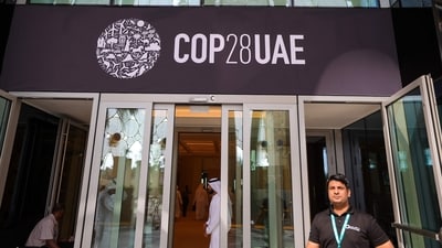 People walk past a COP28 sign at the venue of the United Nations climate summit in Dubai (AFP) People walk past a COP28 sign at the venue of the United Nations climate summit in Dubai (AFP)