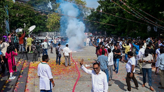 Congress workers burn firecrackers outside the party office to celebrate the party's lead during counting of votes for Telangana Assembly elections. Congress workers burn firecrackers outside the party office to celebrate the party's lead during counting of votes for Telangana Assembly elections.