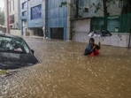 A man wades through a waterlogged road during heavy rain owing to Cyclone Michaung, in Chennai, A man wades through a waterlogged road during heavy rain owing to Cyclone Michaung, in Chennai,