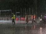 Police personnel on a road during heavy rain owing to Cyclone Michaung in Chennai on Sunday. Police personnel on a road during heavy rain owing to Cyclone Michaung in Chennai on Sunday.
