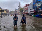 People wade through a waterlogged road during heavy rain owing to Cyclone Michaung, in Chennai (PTI) People wade through a waterlogged road during heavy rain owing to Cyclone Michaung, in Chennai (PTI)