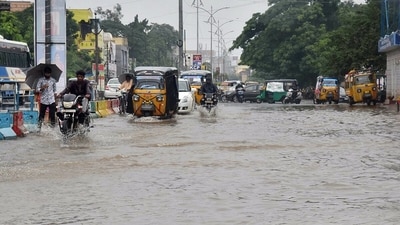 Commuters wade through a waterlogged road following heavy rainfall triggered by 'Severe' Cyclone Michaung, in Andhra Pradesh's Vijayawada on Monday. (ANI) Commuters wade through a waterlogged road following heavy rainfall triggered by 'Severe' Cyclone Michaung, in Andhra Pradesh's Vijayawada on Monday. (ANI)