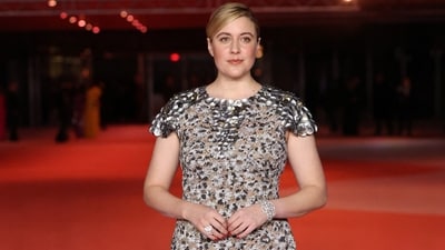 Greta Gerwig attended the event in a grey-coloured dress adorned with floral embroidery and metal embellishments on the neckline. A sleek updo and minimal glam rounded it off.&nbsp; (REUTERS)