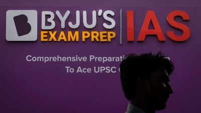 A man walks past an advertising hoarding of Byju's, an Education Technology company and one of India's biggest startup, outside one of its branches in New Delhi (REUTERS)