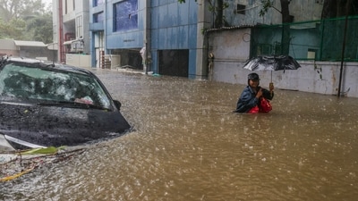 A man wades through a waterlogged road during heavy rain owing to Cyclone Michaung, in Chennai, (PTI) A man wades through a waterlogged road during heavy rain owing to Cyclone Michaung, in Chennai, (PTI)