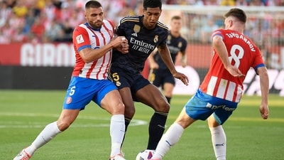 Girona's Spanish midfielder David Lopez fights for the ball with Real Madrid's English midfielder Jude Bellingham during their La Liga match at the Montilivi stadium. (AFP) Girona's Spanish midfielder David Lopez fights for the ball with Real Madrid's English midfielder Jude Bellingham during their La Liga match at the Montilivi stadium. (AFP)