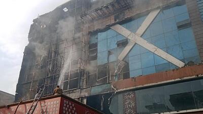 Firefighters try to douse the fire that broke out at Kinsfolk Inn hotel and banquet hall in Vasundhara, Ghaziabad, on Monday. (Sakib Ali/HT Photo)