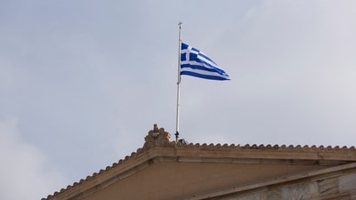 FILE PHOTO: A Greek flag flutters atop the parliament building in Athens, Greece, March 1, 2023. REUTERS/Louiza Vradi/File Photo (REUTERS)