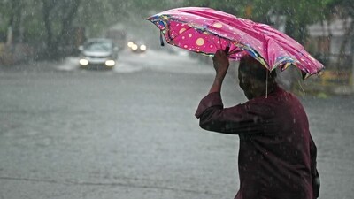 A pedestrian wades through a flooded street after heavy rains in Chennai. (AFP) A pedestrian wades through a flooded street after heavy rains in Chennai. (AFP)