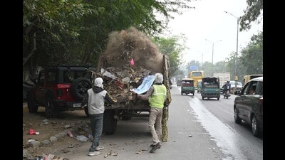 MCG workers clean garbage on the stretch from MDI Chowk to Police Line on Monday. (Parveen Kumar) MCG workers clean garbage on the stretch from MDI Chowk to Police Line on Monday. (Parveen Kumar)