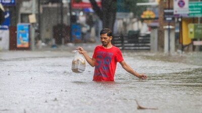 A man wades through a waterlogged road during heavy rain owing to Cyclone Michaung, in Chennai, Monday, Dec. 4, 2023. (PTI) A man wades through a waterlogged road during heavy rain owing to Cyclone Michaung, in Chennai, Monday, Dec. 4, 2023. (PTI)