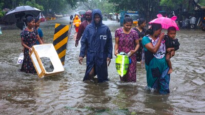 Chennai: People wade through a waterlogged road during heavy rain owing to Cyclone Michaung, in Chennai, Monday, Dec. 4, 2023. (PTI Photo)(PTI12_04_2023_000322A) (PTI) Chennai: People wade through a waterlogged road during heavy rain owing to Cyclone Michaung, in Chennai, Monday, Dec. 4, 2023. (PTI Photo)(PTI12_04_2023_000322A) (PTI)