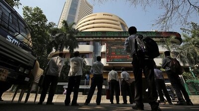 People look at a screen displaying the Sensex results on the facade of the Bombay Stock Exchange (BSE) building in Mumbai. (REUTERS)