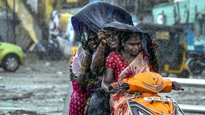 Commuters seen venturing out during heavy rain owing to Cyclone Michaung, in Chennai on Sunday. Due to flooding in Kilyar Bridge near Madhuranthakam, transport to ten villages has been affected. Mahabalipuram-Chengalpattu road is completely flooded and traffic has been cut off. (PTI) Commuters seen venturing out during heavy rain owing to Cyclone Michaung, in Chennai on Sunday. Due to flooding in Kilyar Bridge near Madhuranthakam, transport to ten villages has been affected. Mahabalipuram-Chengalpattu road is completely flooded and traffic has been cut off. (PTI)