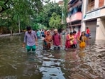 People wade through a flooded road after heavy rainfall owing to Cyclone Michaung, in Chennai. People wade through a flooded road after heavy rainfall owing to Cyclone Michaung, in Chennai.