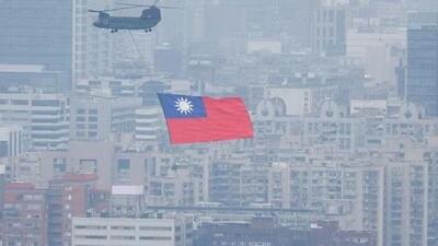A Chinook helicopter carrying a Taiwan flag flies over the city during the country’s National Day celebration in Taipei. (Reuters) A Chinook helicopter carrying a Taiwan flag flies over the city during the country’s National Day celebration in Taipei. (Reuters)