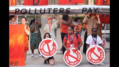 Activists protest against fossil fuels on the sidelines of the COP28 United Nations climate summit in Dubai on Tuesday. (AFP) Activists protest against fossil fuels on the sidelines of the COP28 United Nations climate summit in Dubai on Tuesday. (AFP)