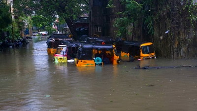 Auto-rickshaws stuck on a waterlogged road during heavy rain owing to Cyclone Michaung, in Chennai. (PTI) Auto-rickshaws stuck on a waterlogged road during heavy rain owing to Cyclone Michaung, in Chennai. (PTI)