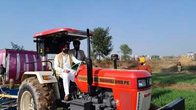 Punjab cabinet minister for rural development and panchayats Laljit Singh Bhullar driving a tractor during a drive. (HT photo)