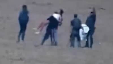 One of the Hamas terrorists is seen propping Amit Soussana on his shoulder in an attempt to get her to be still (Channel 12) One of the Hamas terrorists is seen propping Amit Soussana on his shoulder in an attempt to get her to be still (Channel 12)