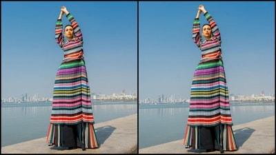 Her dress featured a scoop neck, balloon pattern full sleeves, net fabric, fitted bodice, midi hemline and a vibrant horizontal print all over adding an oomph factor. She paired it with matching flared trousers. (Instagram/@therealkarismakapoor) Her dress featured a scoop neck, balloon pattern full sleeves, net fabric, fitted bodice, midi hemline and a vibrant horizontal print all over adding an oomph factor. She paired it with matching flared trousers. (Instagram/@therealkarismakapoor)
