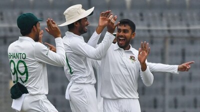 Bangladesh's Mehidy Hasan Miraz (R) celebrates with teammates after taking the wicket of New Zealand's Devon Conway (not pictured) during the first day of the second Test (AFP) Bangladesh's Mehidy Hasan Miraz (R) celebrates with teammates after taking the wicket of New Zealand's Devon Conway (not pictured) during the first day of the second Test (AFP)