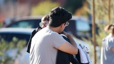 TOPSHOT - Student Amanda Perez, 23, is comforted by fiance Alejandro Barron, 24, following a shooting at the University of Nevada, Las Vegas, campus in Las Vegas on December 6, 2023. (Photo by Ronda Churchill / AFP) TOPSHOT - Student Amanda Perez, 23, is comforted by fiance Alejandro Barron, 24, following a shooting at the University of Nevada, Las Vegas, campus in Las Vegas on December 6, 2023. (Photo by Ronda Churchill / AFP)