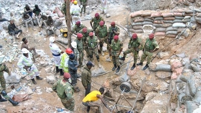 Zambian Army special forces officers follow the rescue operation of miners (AP) Zambian Army special forces officers follow the rescue operation of miners (AP)