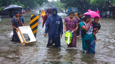 Chennai: People wade through a waterlogged road during heavy rain owing to Cyclone Michaung, in Chennai, Monday, Dec. 4, 2023. (PTI) Chennai: People wade through a waterlogged road during heavy rain owing to Cyclone Michaung, in Chennai, Monday, Dec. 4, 2023. (PTI)