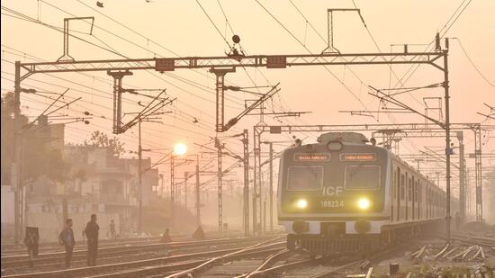 Ghaziabad , India - December 06 2023: A passenger train runs amid heavy smoke Kotgaon railway track near Junction railway station in Ghaziaba , India on Wednesday, December 06 2023. (Photo by Sakib Ali /Hindustan Times)
