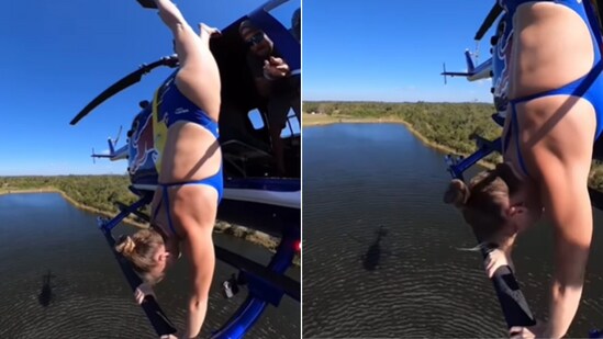 The image shows a woman doing a handstand on a flying helicopter. (Instagram/@ellietsmart)